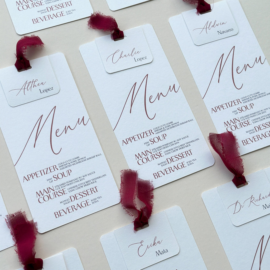 Set of menu cards with names and red ribbons on a light background